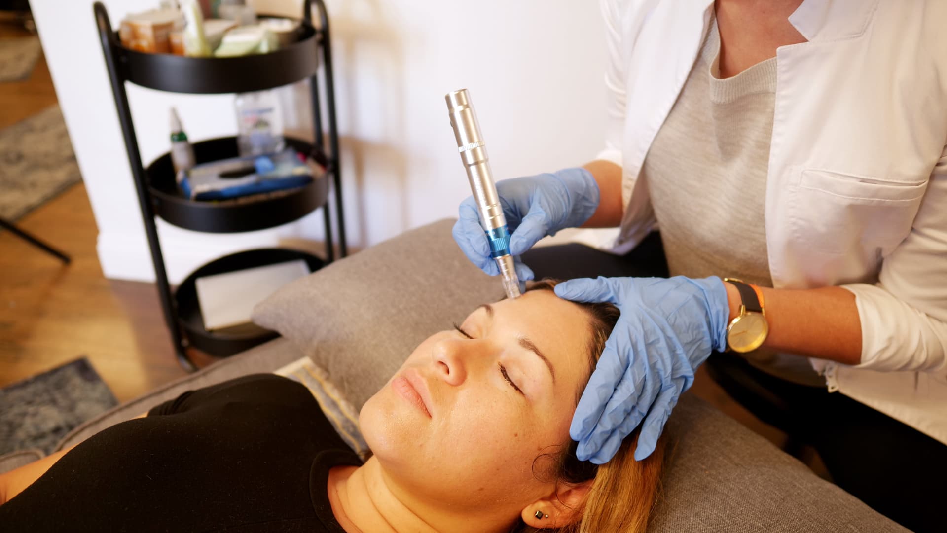 Licensed practitioner performing microneedling treatment on the face